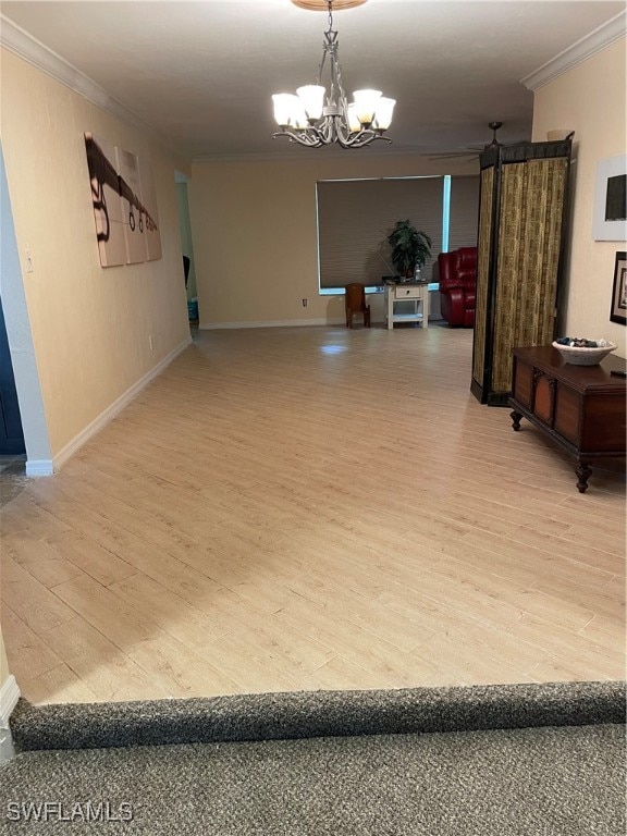 interior space featuring a notable chandelier, crown molding, and light hardwood / wood-style flooring