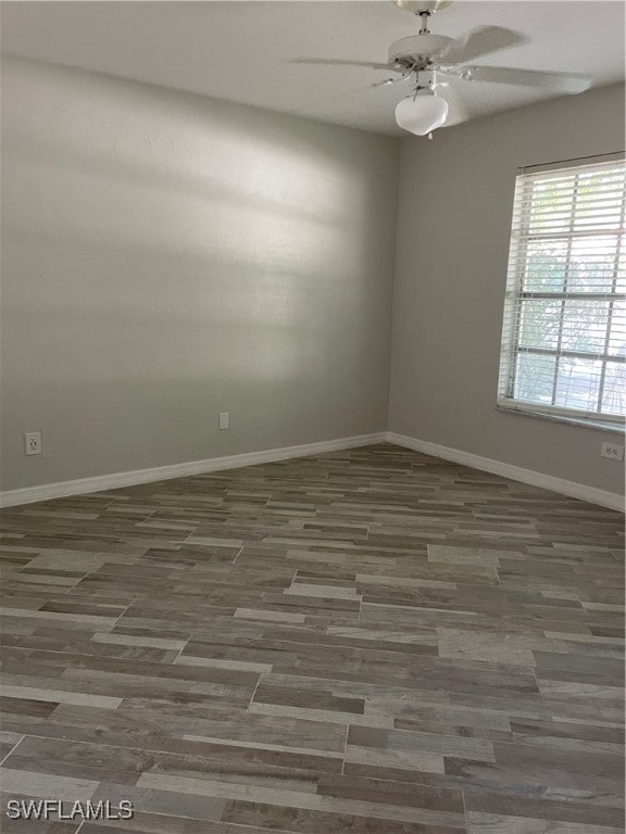 spare room with ceiling fan and dark hardwood / wood-style flooring