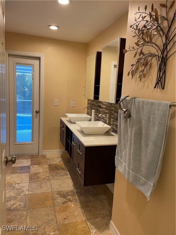 bathroom with vanity and decorative backsplash