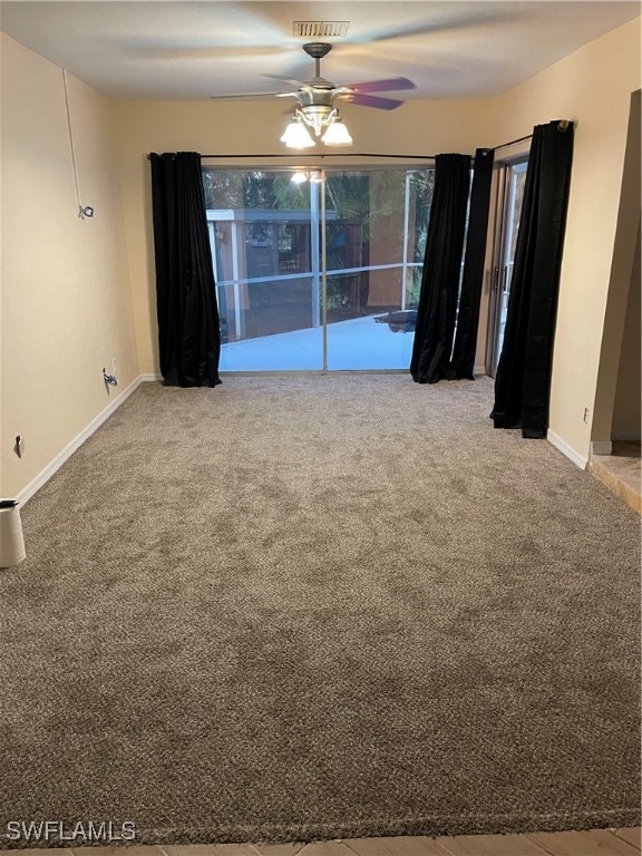 carpeted spare room featuring ceiling fan