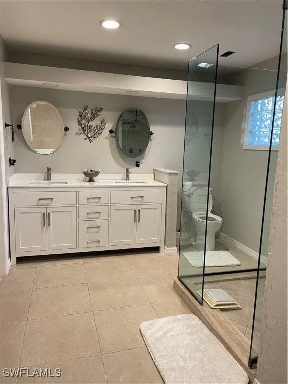 bathroom with a shower with shower door, tile patterned flooring, toilet, and vanity