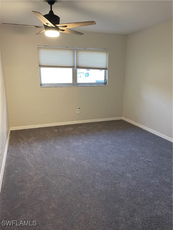 carpeted empty room featuring ceiling fan