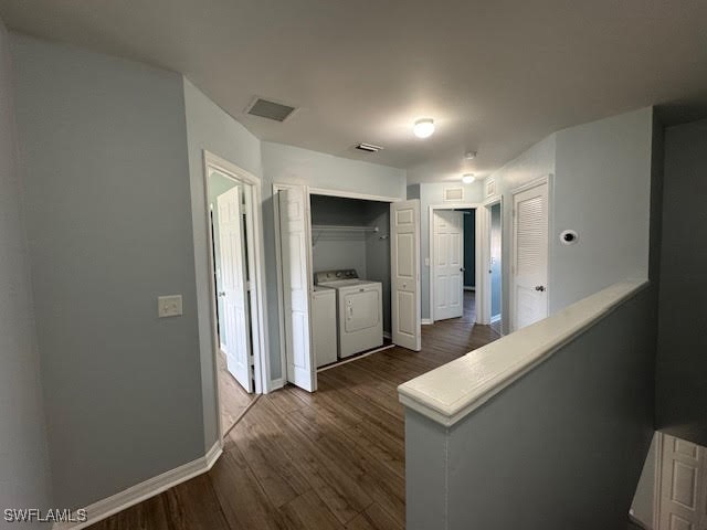 hallway featuring washer and clothes dryer and dark hardwood / wood-style floors