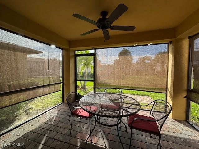 sunroom / solarium featuring ceiling fan