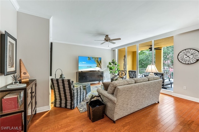 living room featuring ceiling fan, ornamental molding, and hardwood / wood-style floors