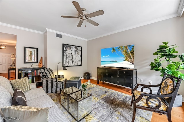 living room with hardwood / wood-style floors, ceiling fan, and ornamental molding