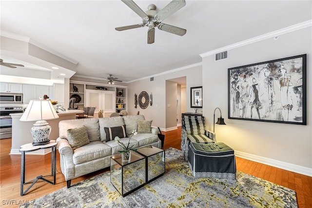 living room with ceiling fan and light hardwood / wood-style flooring