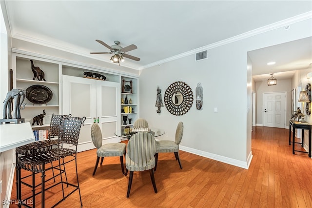 dining area with crown molding, ceiling fan, and hardwood / wood-style floors