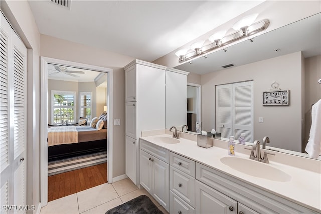 bathroom featuring vanity, ceiling fan, ornamental molding, and tile patterned floors