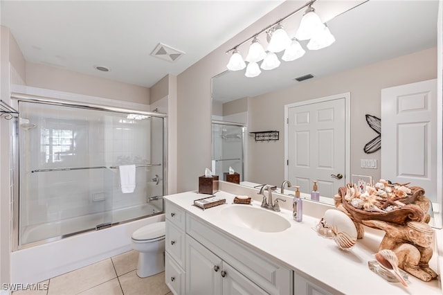 full bathroom with tile patterned flooring, vanity, toilet, and bath / shower combo with glass door