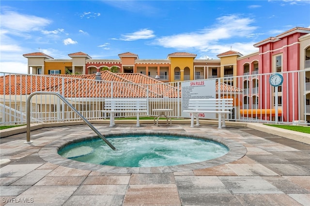 view of swimming pool with a community hot tub