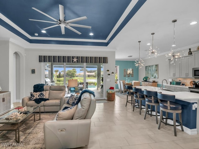 14748 Windward Ln, Naples, FL 34114 - living area featuring crown molding, ceiling fan with notable chandelier, arched walkways, recessed lighting, and a raised ceiling