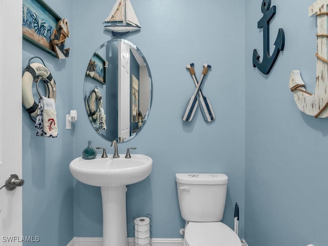 14748 Windward Ln, Naples, FL 34114 - half bathroom featuring toilet and baseboards