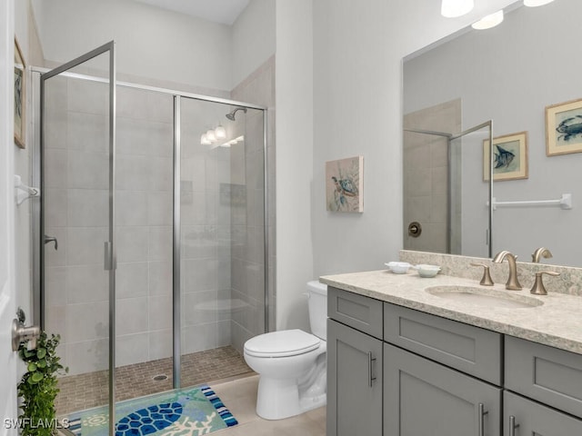 bathroom with an enclosed shower, tile patterned floors, vanity, and toilet