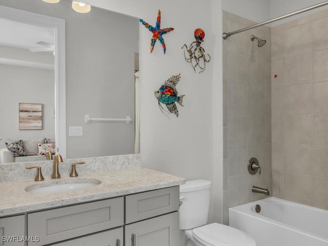 14748 Windward Ln, Naples, FL 34114 - full bathroom featuring toilet, vanity, and washtub / shower combination