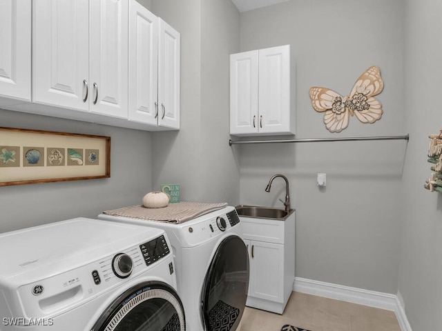 laundry area with sink, light tile patterned flooring, cabinets, and washing machine and clothes dryer