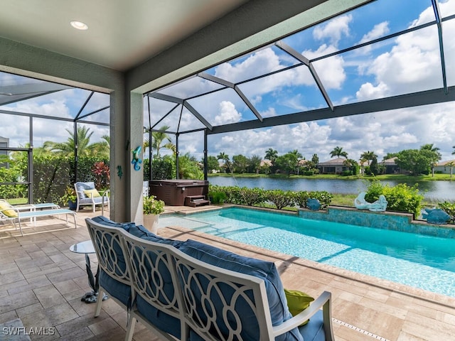 view of pool with glass enclosure, a patio area, a hot tub, and a water view