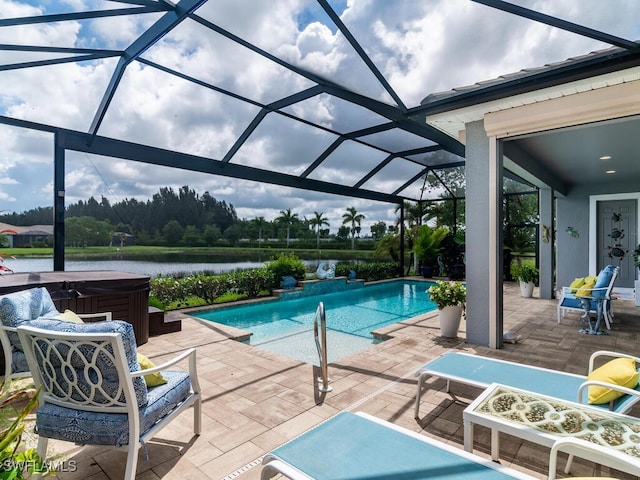 view of pool with a patio, a water view, a lanai, and a hot tub