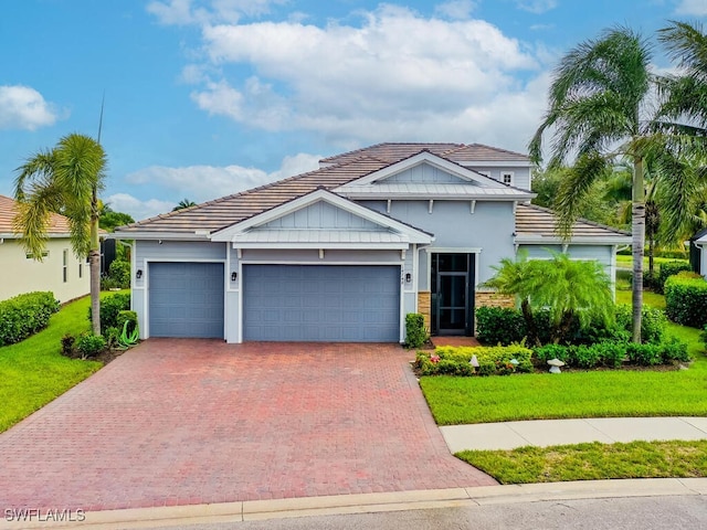 14748 Windward Ln, Naples, FL 34114 - view of front facade with a front yard, decorative driveway, an attached garage, and a tile roof