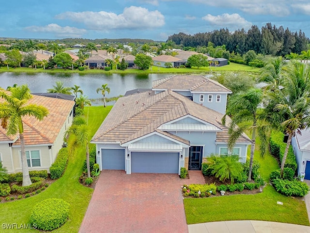 view of front of home featuring a garage and a water view