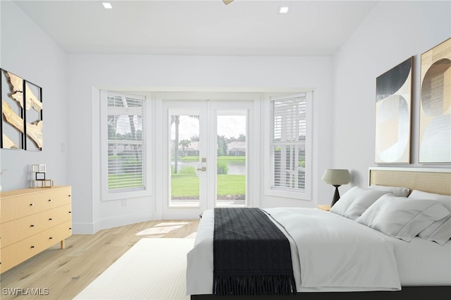 bedroom with multiple windows and light hardwood / wood-style floors