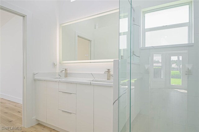 bathroom featuring vanity, hardwood / wood-style floors, and an enclosed shower