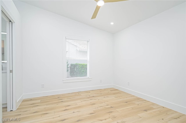 empty room featuring light wood-type flooring, lofted ceiling, and ceiling fan