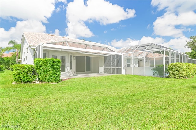 rear view of house featuring a lawn, a lanai, and a patio