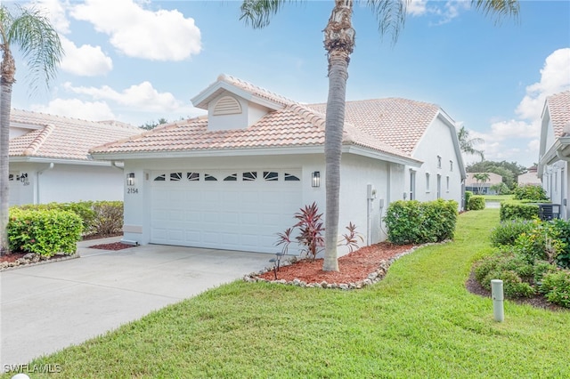 view of front of home featuring a front yard and a garage