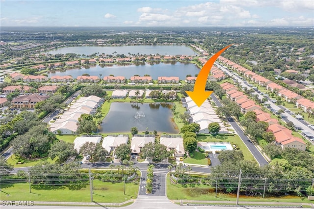 birds eye view of property with a water view