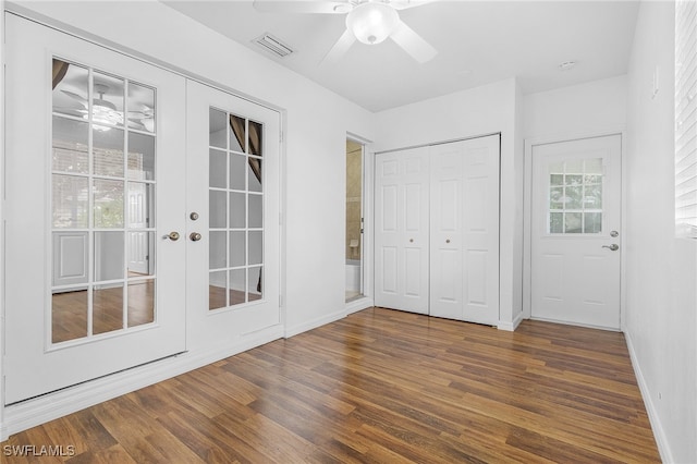 interior space featuring french doors, a closet, ceiling fan, and dark hardwood / wood-style floors