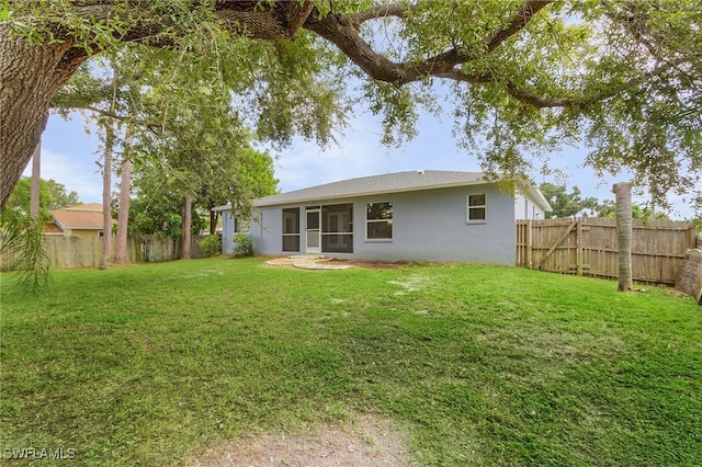 back of house with a yard