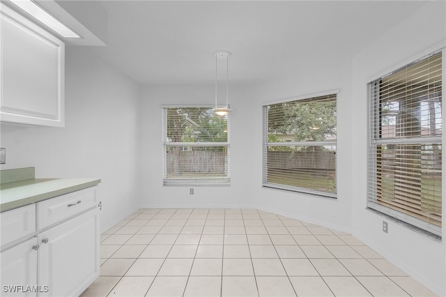 unfurnished dining area featuring light tile patterned flooring