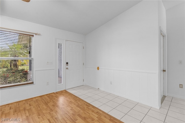 foyer with lofted ceiling and light hardwood / wood-style flooring