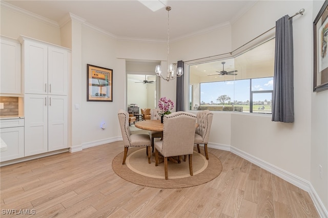 dining room with crown molding, an inviting chandelier, and light wood-type flooring