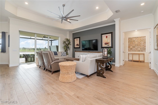 living room featuring ceiling fan, light hardwood / wood-style flooring, and ornamental molding