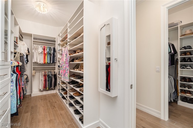 walk in closet featuring light hardwood / wood-style flooring