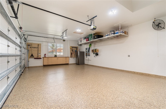 garage featuring stainless steel fridge and a garage door opener