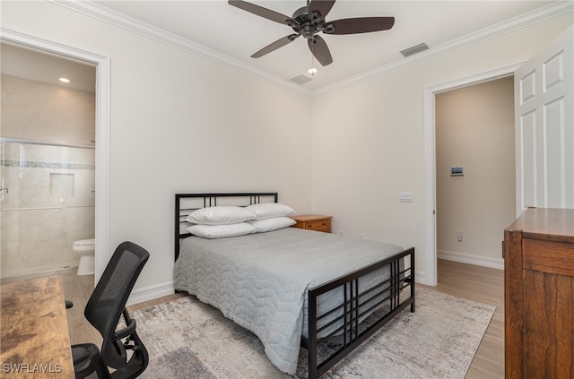 bedroom featuring light wood-type flooring, ensuite bathroom, ceiling fan, and ornamental molding