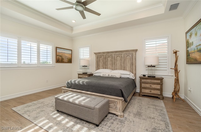 bedroom with ceiling fan, light hardwood / wood-style floors, and ornamental molding