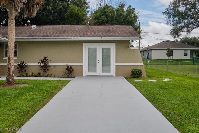 view of front of house with a front lawn and french doors