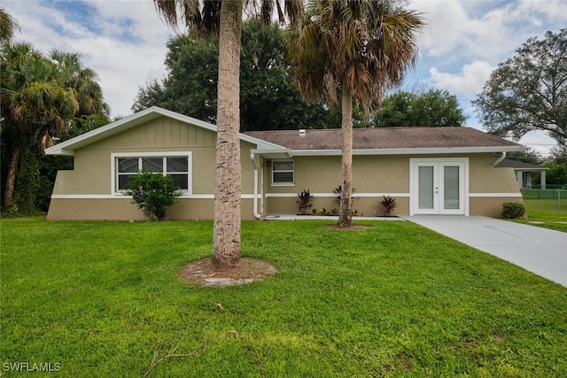 single story home with a front yard and french doors