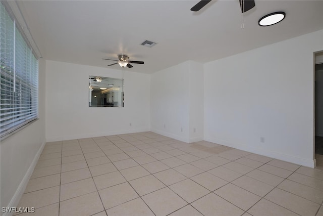 tiled empty room with ceiling fan