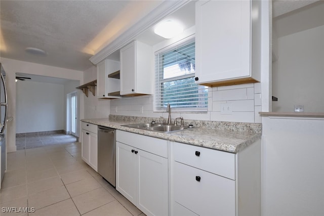 kitchen with backsplash, white cabinets, dishwasher, and sink