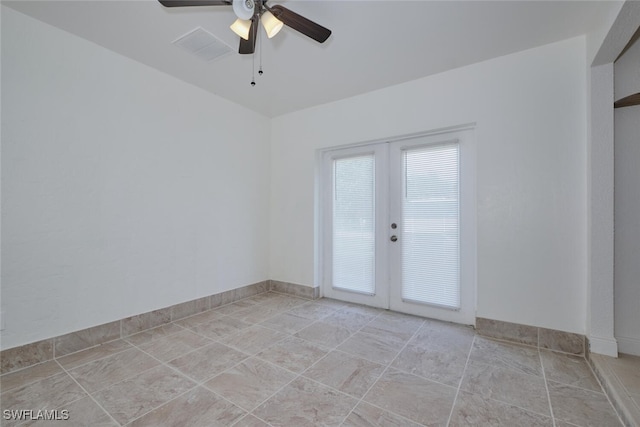 empty room with ceiling fan and french doors