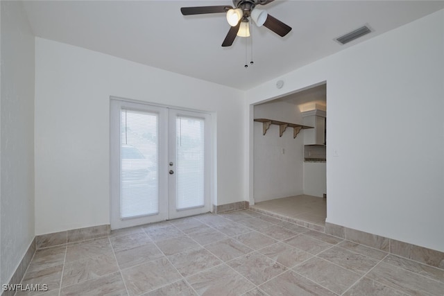 unfurnished room with ceiling fan and french doors