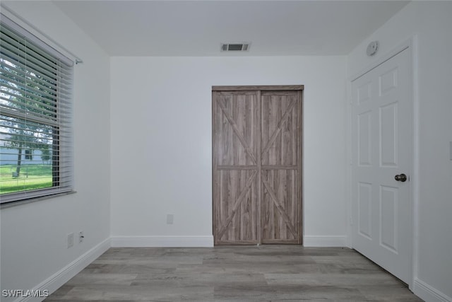 unfurnished bedroom featuring light wood-type flooring