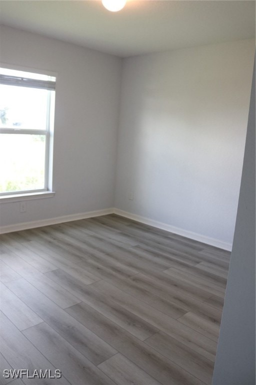 unfurnished room with wood-type flooring