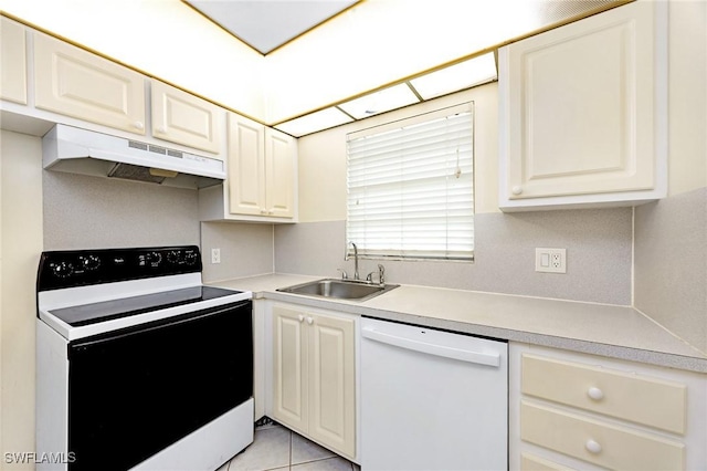 kitchen featuring sink, light tile patterned floors, and white appliances