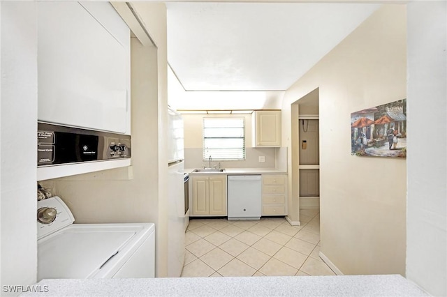 kitchen with dishwasher, light tile patterned flooring, washer / dryer, and sink